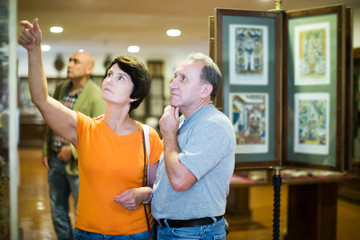 Man and his wife are visiting museum