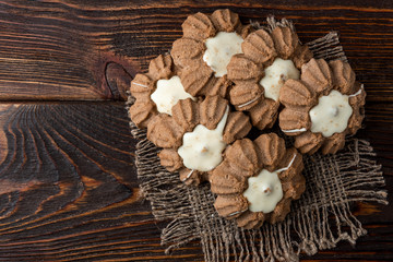 Chocolate shortbread cookies on dark wooden background.