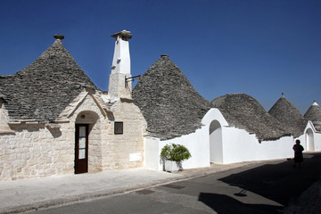 Alberobello, Italy - 07.17.2017: Trullas - traditional stone houses with a conical roof, included in the UNESCO World Heritage List