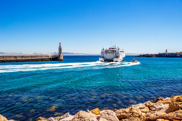 The Maltese Virtu Ferries catamaran Maria Dolores passes by Punta del Santo at the Port of Tarifa, Province of Cadiz, Andalusia Spain © Stanislava