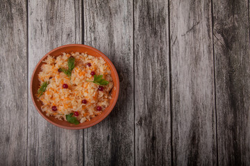salad of fermented cabbage and cranberries with herbs stands on a wooden brown table