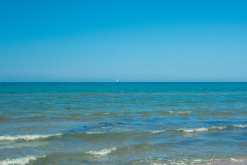 the blue sky over the calm sea with the reflection of sunlight. Calm sea harmony of calm water surface. Sunny sky and calm blue ocean.