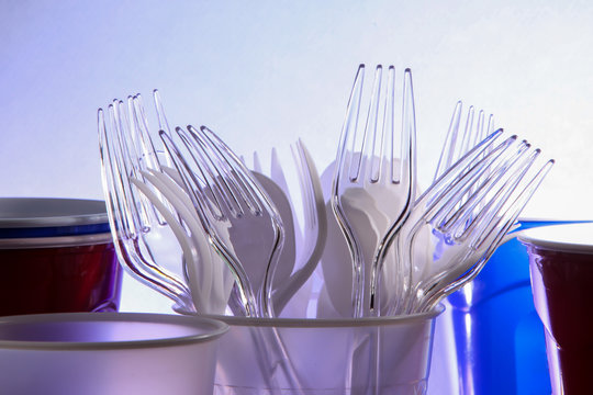 Plastic utensil inside plastic cups with backlight