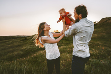 Happy family walking with infant baby outdoor mother and father parents lifestyle traveling summer...