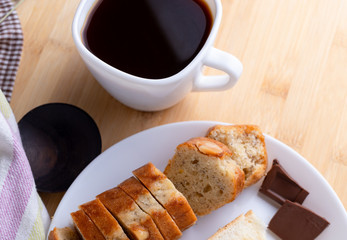Pastry and black coffee on wooden table
