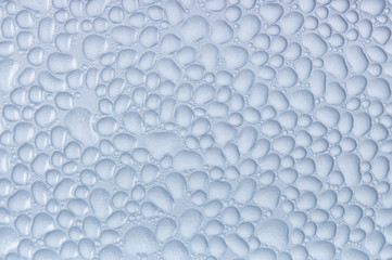 Drops of condensate on the surface of a plastic bottle, close-up