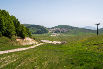 Fototapeta premium Mountains of Roccaraso with skilifts in summer, the (plateau) Piano Aremogna and Pizzalto, Monte Greco, Monti Marsicani highest group of Apennines. L'Aquila, Abruzzo, Italy