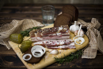 Appetizing piece of homemade salted pork lard for a snack. Rural healthy food.
