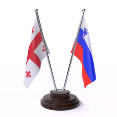 Georgia and Slovenia, two table flags isolated on white background. 3d image