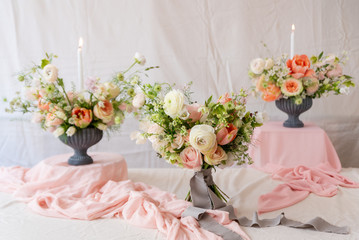 Still life with  beautiful bouquets of flowers and candles