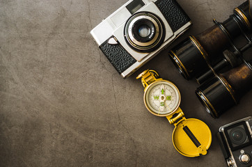 old, retro travel accessories - compass, binoculars, analogue camera, flat lay 