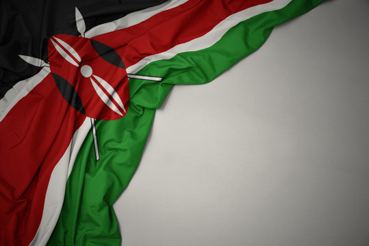 waving national flag of kenya on a gray background.