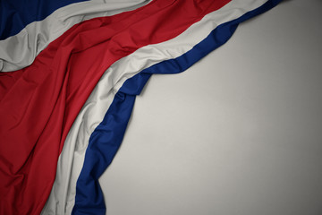 waving national flag of costa rica on a gray background.