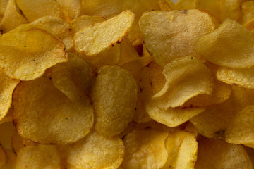 Texture fried golden brown potato chips, close-up