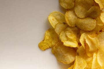 golden brown potato chips on a white background.