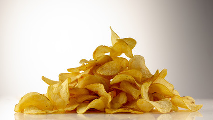 golden brown potato chips on a white background.