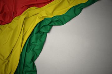 waving national flag of bolivia on a gray background. - obrazy, fototapety, plakaty