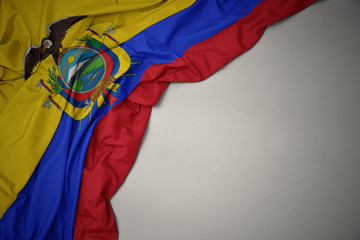 waving national flag of ecuador on a gray background.