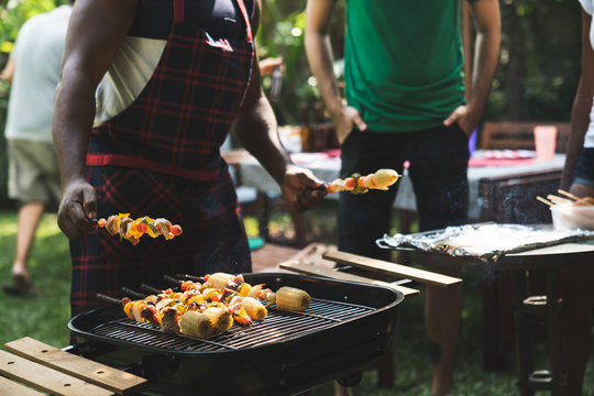 Group of friends at summer outdoor party and holidays concept.