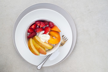Sliced strawberry, apricot and apple with cottage cheese and sour cream