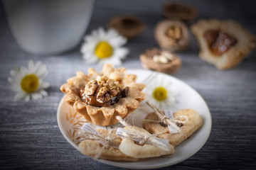 Homemade baking. Shortcake dough baskets with walnuts and condensed milk.