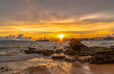 Obraz premium sunset above industry pier at Kwang beach.there have beautiful rock along the beach. Kwang beach is quiet and beautiful beach in Krabi