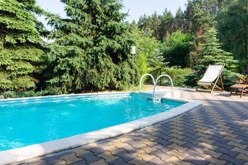 Outdoor pool with blue water in the forest park