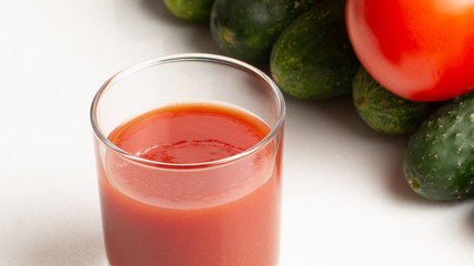 Fresh tomato juice on white background close up