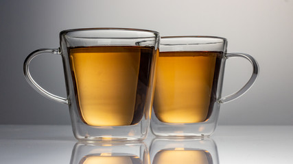 green tea with jasmine in a transparent glass thermomug on a white background