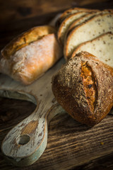Homemade healthy whole grain bread on rustic wooden background
