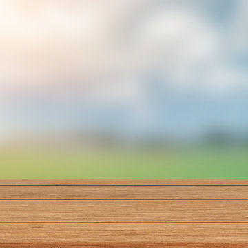 abstract blurred agricultural farm field with brown wood deck terrace for ads banner,show,promote product content on image concept