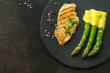 asparagus and meat fillets grill, hollandaise sauce. food background. top