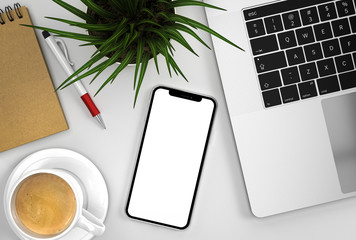 Smartphone blank screen next to laptop with coffee and grass flower	