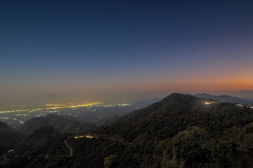 sunset at Doi Ang Khang, Mountain view evening of top hill around with soft fog and yellow sun light in the sky background, Monzone Camping Zone, Doi Angkhang, Chiang Mai, Thailand.