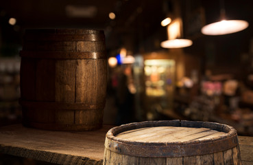 Beer barrel with beer glasses on a wooden table. The dark brown background.