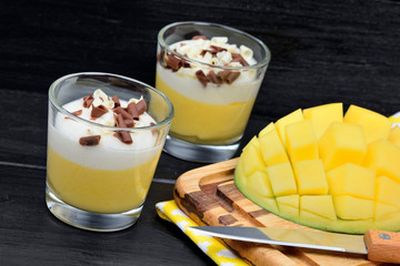 Mousse of mango in a glasses on wood table