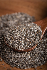 dried chia seeds on wood spoon