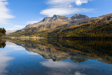 beautiful reflection from the mountains in the lake Silsersee, Graubünden, Switzerland