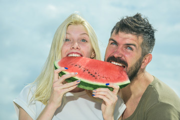 Watermelon as a symbol of summer, unity and oneness. Portrait of happy couple enjoying watermelon on summer holiday, having fun together.
