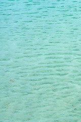 Waving surface of a clear blue water as a natural background. Blue lagoon.  