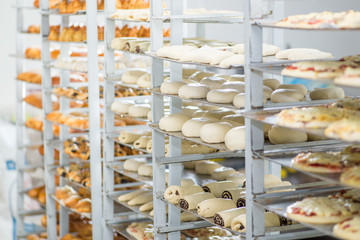 racks with finished and raw dough products in a bakery