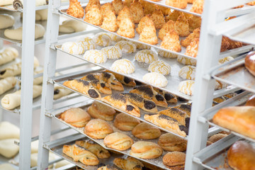 racks with finished and raw dough products in a bakery