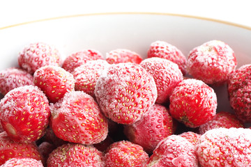 Frozen strawberry berries covered with hoarfrost in a plate...