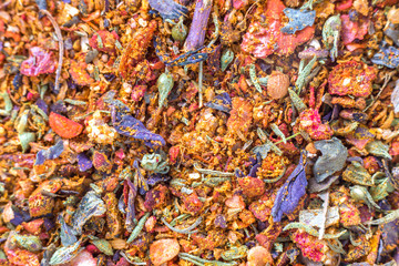 Abstract textured natural bright orange colorful copy space background. Millet, oak, different grains small particles, fish and parrot food.