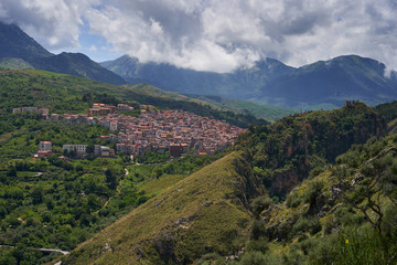 Fototapeta na wymiar Landscape Picture of beautiful small mediaeval town or village Isnello to be located in Madonie mountain range in Italy in Palermo Province of island Sicily. Picture is taken in cloudy spring day.