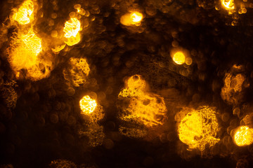 Golden shiny lights bokeh background. Yellow glittering blurred texture. Lights and bubbles abstract defocused background.