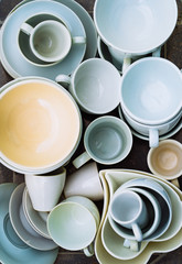 Heap of different crockery, porcelain and ceramic dishes. Bowl, plates and cups. Close up
