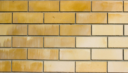  Light brown brickwork. Bricks of different shades of yellow and brown colors.