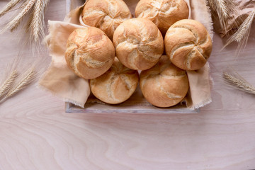 Crusty round bread rolls, known as Kaiser or Vienna rolls on linen towel,