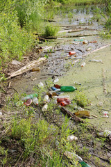 plastic bottles of beer and lemonade thrown into the pond. garbage, waste, environmental pollution